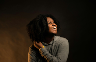 Young Black mother smiling with genuine joy